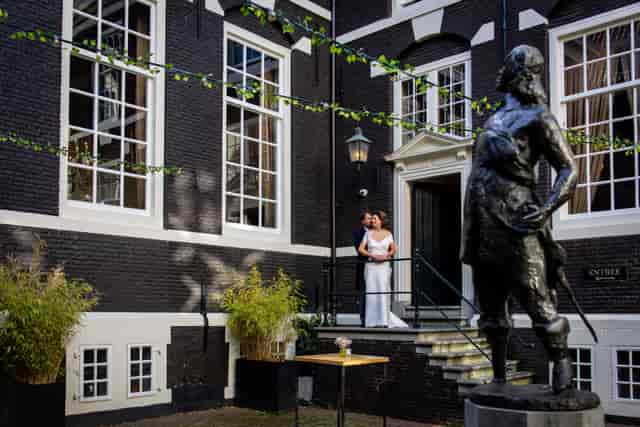 Historic courtyard at Het West-Indisch Huis with bistro lighting for luxury event venues.