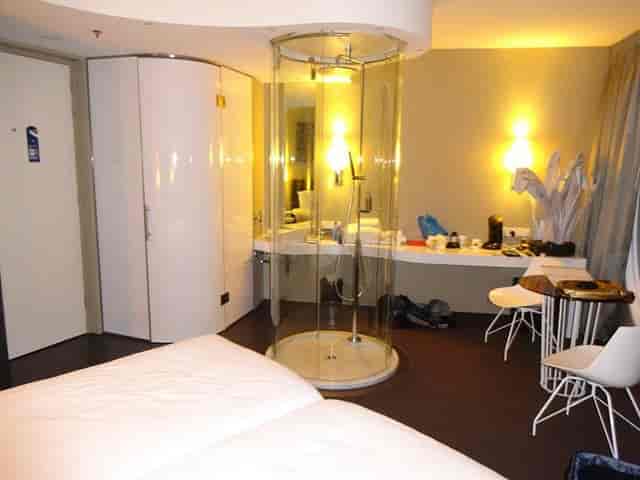 Fletcher Hotel Amsterdam room with glass shower; poor privacy layout for corporate business travel.