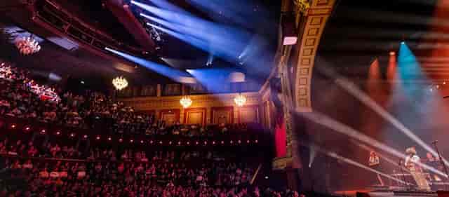General session at Theater Amsterdam with dramatic lighting for corporate event production.