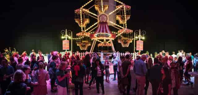 Indoor carnival-themed event at Blackbox Amsterdam featuring a branded Ferris wheel for networking.