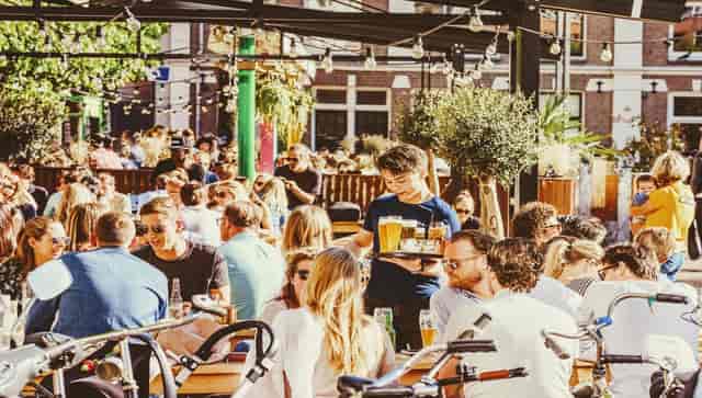 Outdoor hospitality event at BCN Amsterdam with communal seating and ambient lighting.