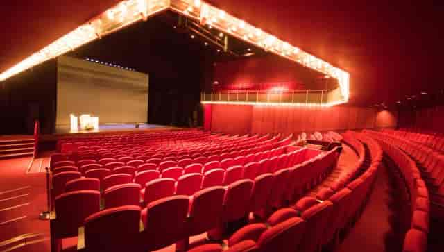 Tiered auditorium with large screen for keynote presentations and plenary sessions.