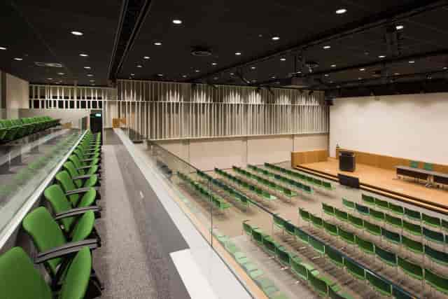 Modern tiered auditorium at SustainaLab for corporate presentations and educational seminars.