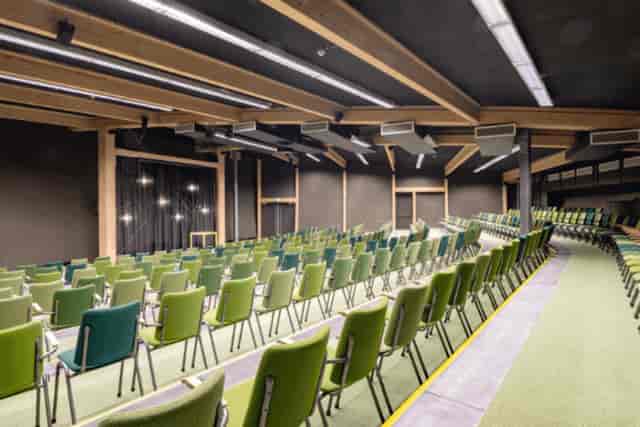 Modern EXPO Greater Amsterdam auditorium with theater seating for corporate presentations.