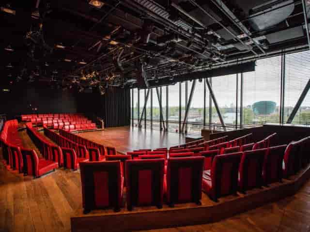 ijVENUES black box conference space with tiered seating for product launches and creative workshops.