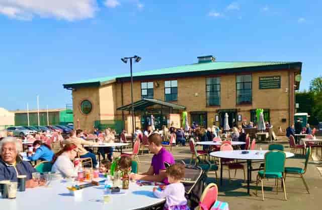 Emerald Venues outdoor grass area with casual patio seating for networking and social events.