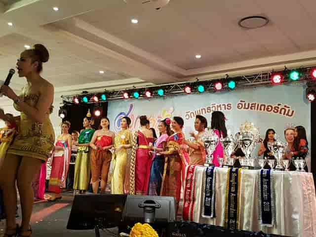 Stage setup for cultural awards ceremony at Palmyra event center with participants and trophies.