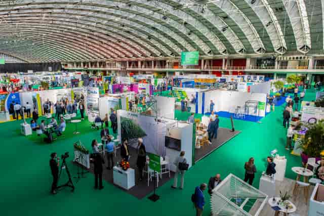 GreenTech exhibition hall, spacious modular booths, networking event, trade show venue.