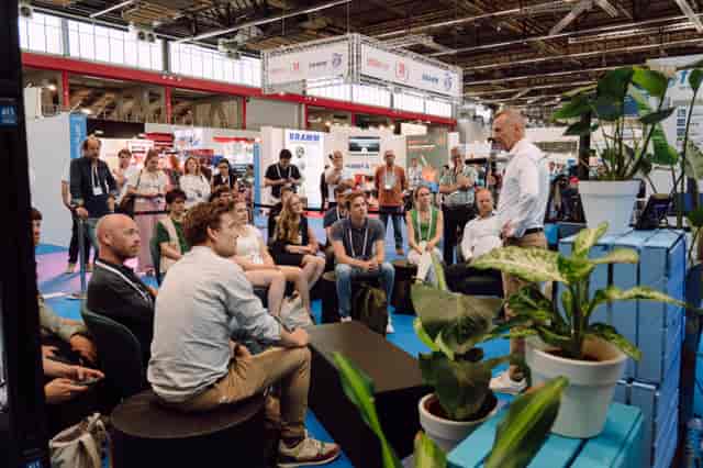 GreenTech trade show event: casual tiered seating for intimate speaker session and networking.