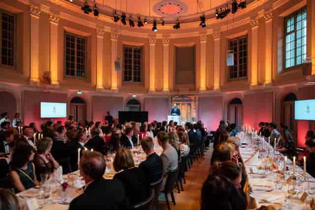 Felix Meritis concert hall banquet setup with communal tables for corporate events and conferences.