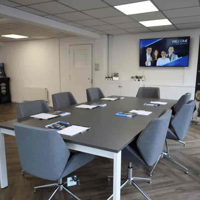 Boardroom setup in Paragon Creative Studios featuring digital display for corporate events or meetings.