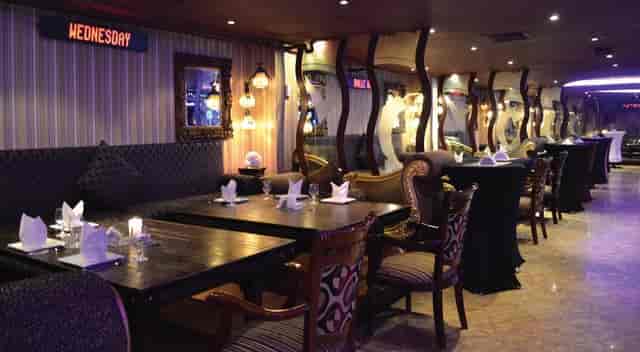 Ramee Royal Hotel suite with lounge seating and high-top tables for corporate reception or dinner.