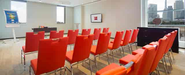 Dubai World Trade Centre meeting room with orange chairs for corporate training and presentations.