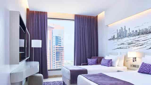 Modern hotel twin room in Mercure Dubai Barsha Heights for business travel and conference booking.