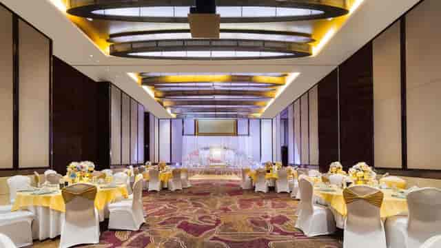 Pillar-free ballroom at Swissôtel Al Ghurair featuring mood lighting for gala or wedding events.