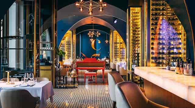Trattoria by Cinque red piano: elegant private dinner and networking event venue.