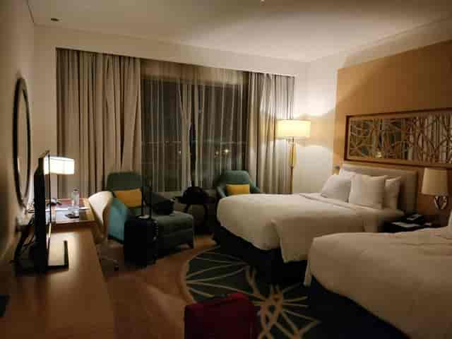 Double-occupancy hotel room in Dubai with ergonomic workspace, ideal for conference event blocks.