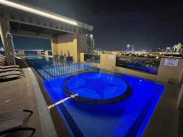 Rooftop VIP reception at Marriott Al Jaddaf, Dubai with dramatic skyline views and pool lighting.