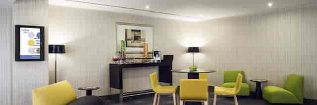 Contemporary breakout area with refreshments at Novotel Dubai for corporate meetings and events.