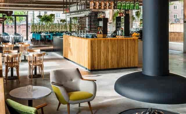 PARK Café in Hotel Arena Amsterdam with a warm wooden bar, perfect for meetings and events.