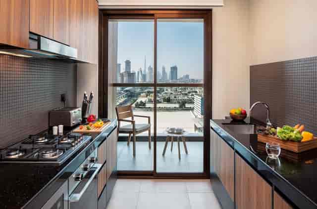 Modern kitchen with city view at DoubleTree Dubai, perfect for events and workshops.