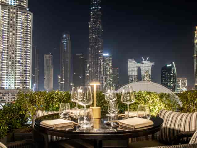 Private dining rooftop venue with skyline backdrop for corporate events and networking receptions.