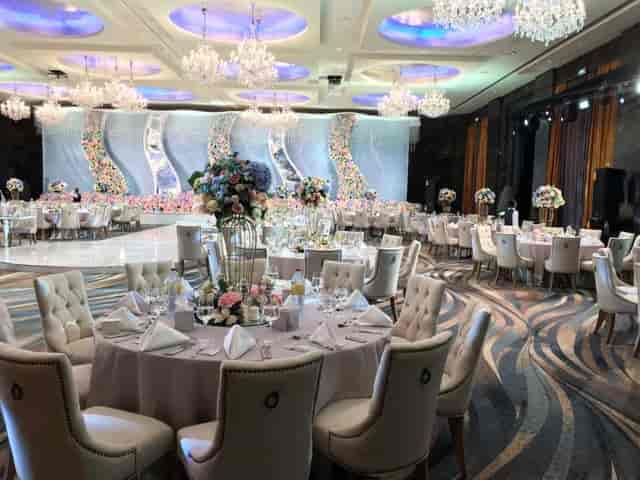 Luxury ballroom wedding setup with tiered floral decor for gala events at Raffles Dubai.