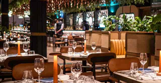 Sophisticated Clay Restaurant interior with premium booth seating for corporate and networking events.