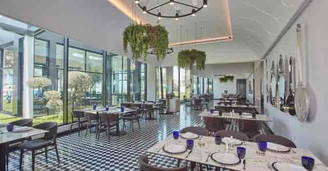 Em Sherif Sea Café: Checkered floor, biophilic design, corporate lunch and networking venue.