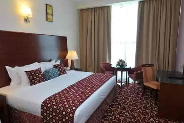 Upscale hotel room with workspace for business travel and event delegate accommodation.