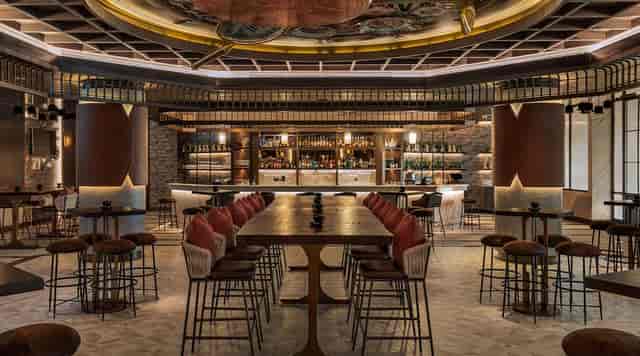 Mediterranean restaurant with communal seating for upscale corporate networking and happy hours.