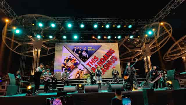 Band performing on LED-lit truss stage for live entertainment and concert event production.