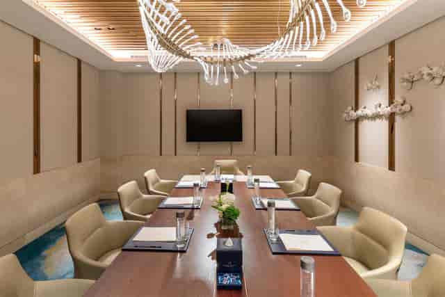 Luxury boardroom with statement chandelier for executive strategy sessions and corporate meetings.