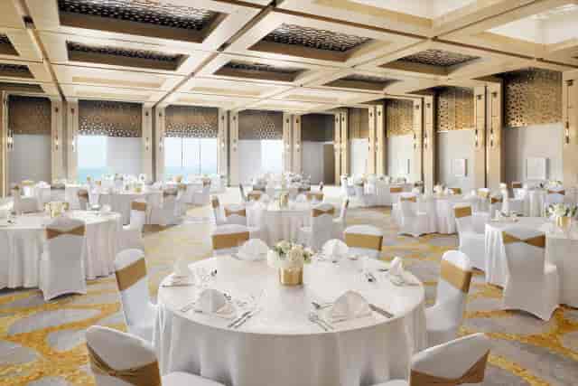 Lateen ballroom with gold decor: luxury corporate event and gala dinner venue in Ras Al Khaimah.