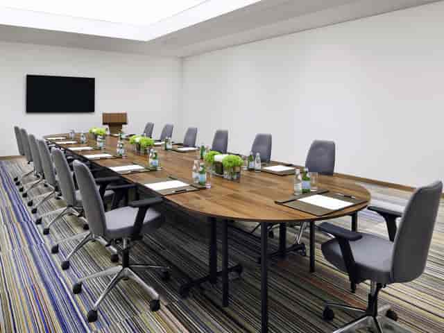 Boardroom with wooden table for executive meetings and corporate events.