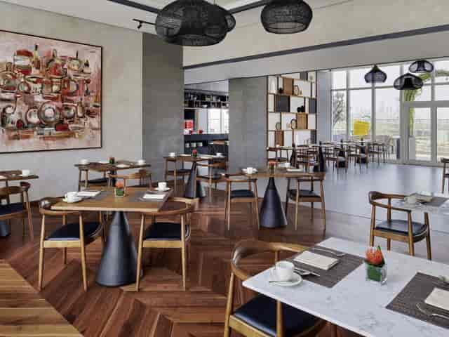 Upscale F&B space with modular design for boutique networking receptions and executive meetings.