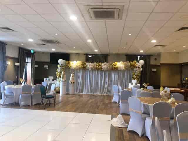 Emerald Hall event space with gold and white balloon arch for wedding and party venue rentals.