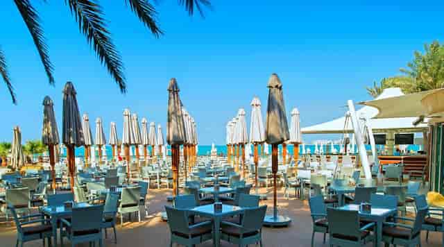 Wave Breaker, Address Beach Resort: vibrant outdoor event venue with ocean view and stylish umbrellas.