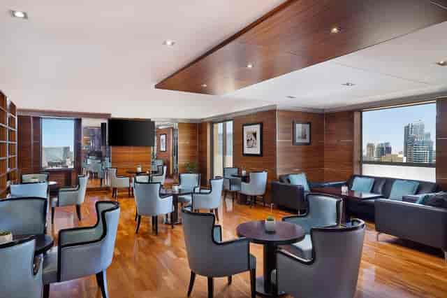 Executive Lounge at Hilton Dubai, modern meeting space with natural light, ideal for events.