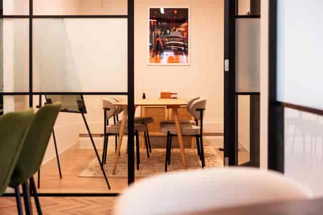 Modern Tyburn meeting room with glass walls for 4-person strategy sessions and private consultations.