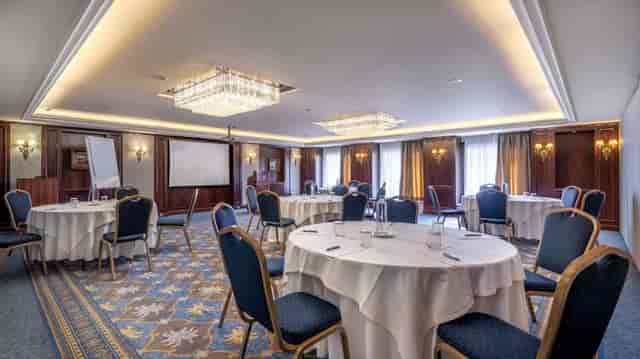 Elegant Electra Palace Athens ballroom with round tables for corporate events and gala meetings.