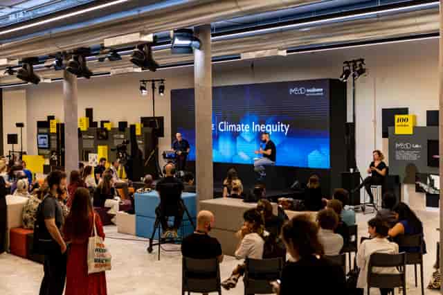 Corporate panel discussion at Arts Lounge Athens Conservatoire with LED backdrop and modern decor.