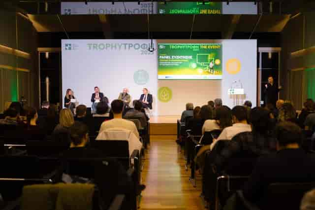 Panel discussion at Aris Garoufalis Auditorium, Athens: professional stage setup for events.