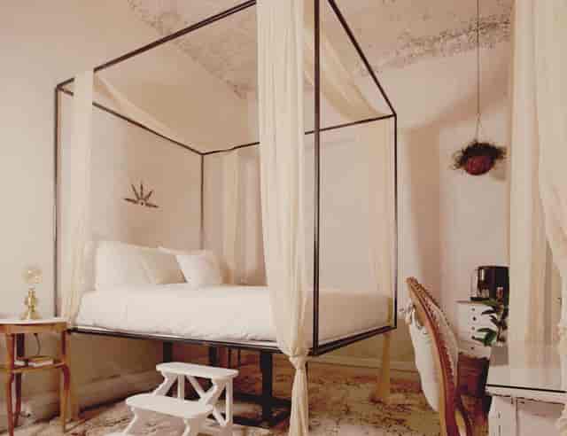 The Dreamers at Shila Athens: minimalist canopy bed for luxury event and VIP travel accommodation.