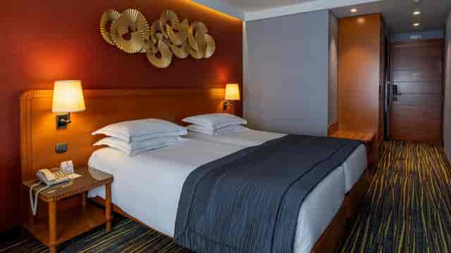 Twin hotel room at ATLAS President Hotel Athens for business group accommodation and events.