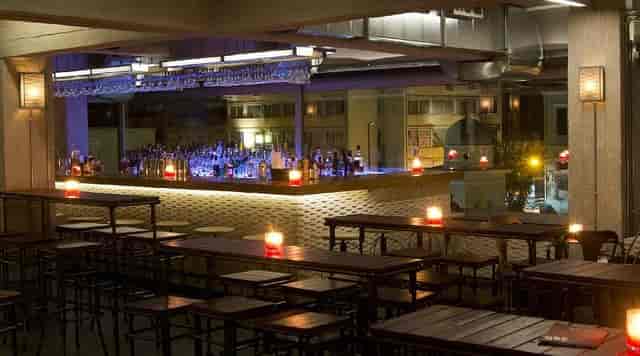 Modern cocktail bar with mood lighting, ideal for networking reception and corporate event venue.