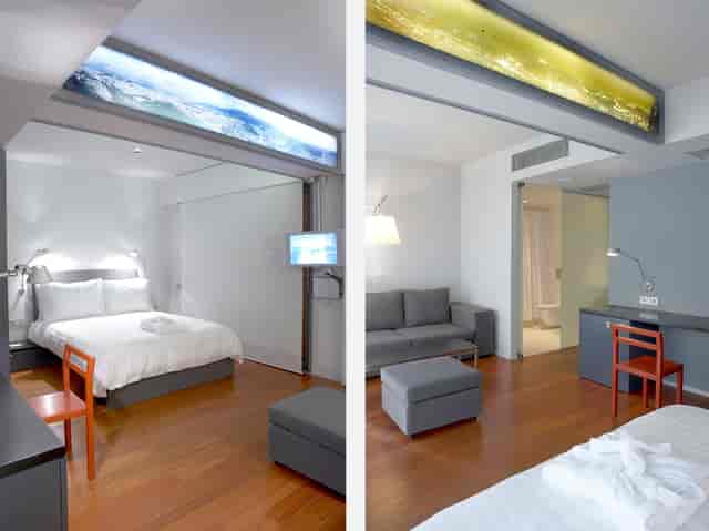 Dual-zone hotel suite for executive travel, featuring a workspace and sleeping area.