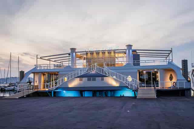 Ploes Venue waterfront terrace with multi-level layout for upscale corporate event networking.