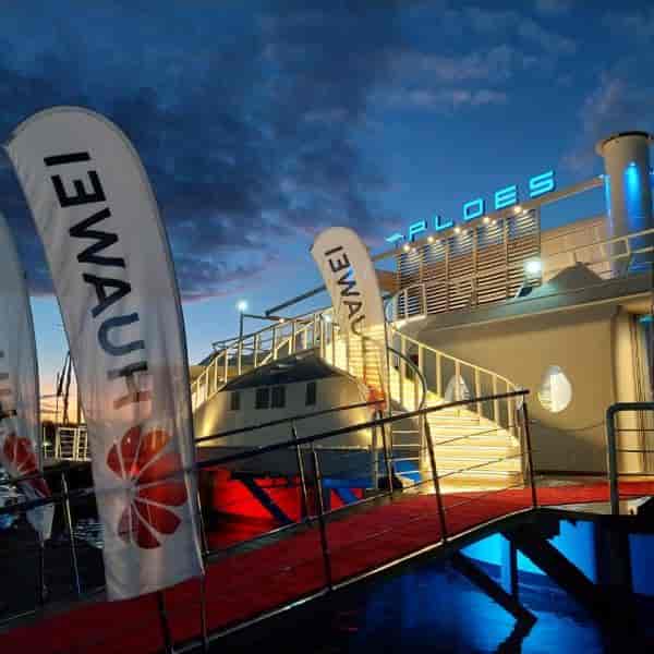 Branded waterfront lounge deck at Ploes Venue with red carpet for corporate events and activations.