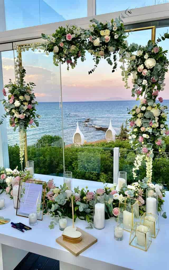 Luxury oceanfront wedding venue with vertical floral arches for high-end incentive events.